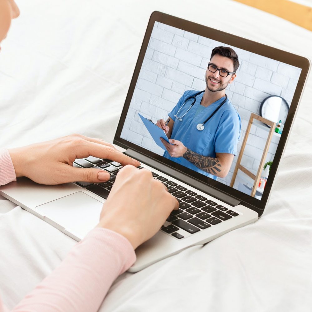 Telehealth concept. Young woman having video conference with her doctor, consulting therapist online